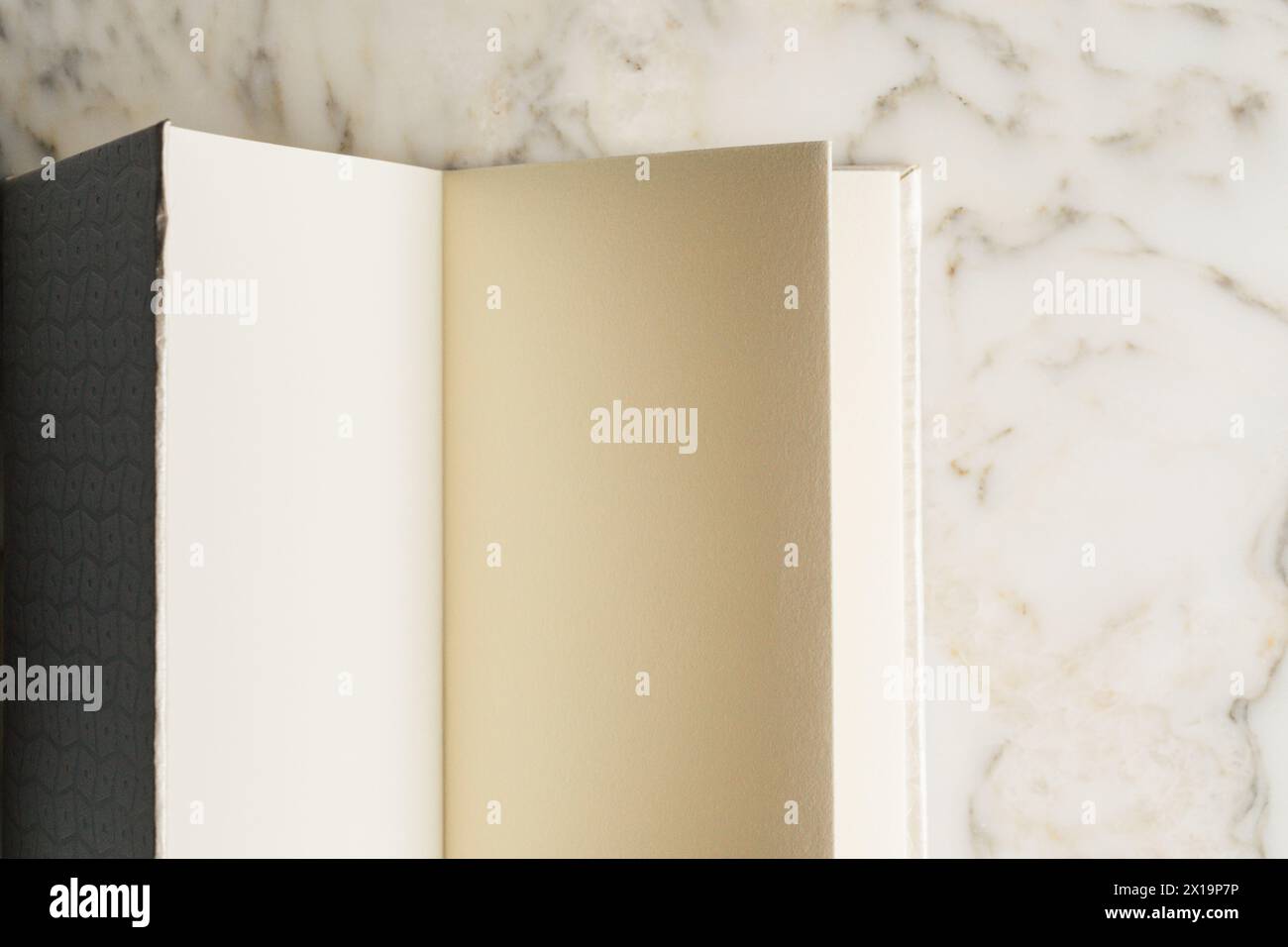 blank pages in handmade book on white marble table Stock Photo