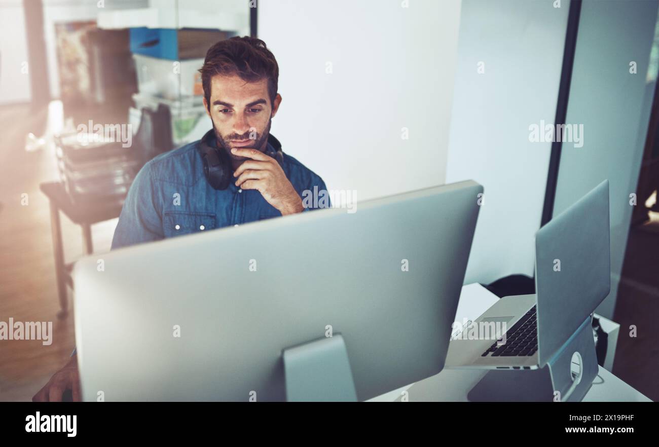 Idea, computer and business man reading email, thinking or problem solving in creative startup office. Pc, serious programmer and planning solution Stock Photo