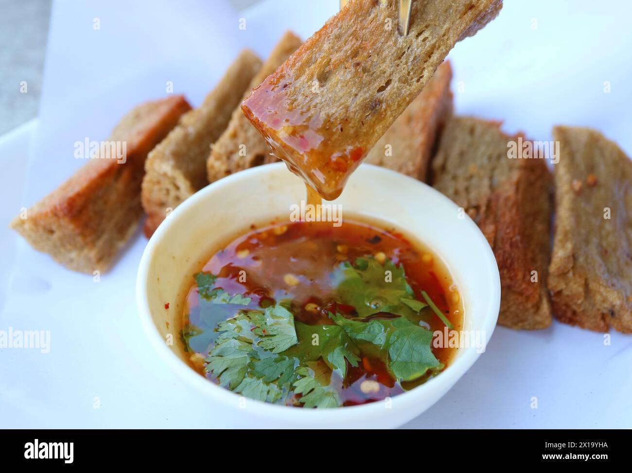 Delectable Crispy Fish Crackers or Kropek Dipping Sweeten Chili Sauce Stock Photo