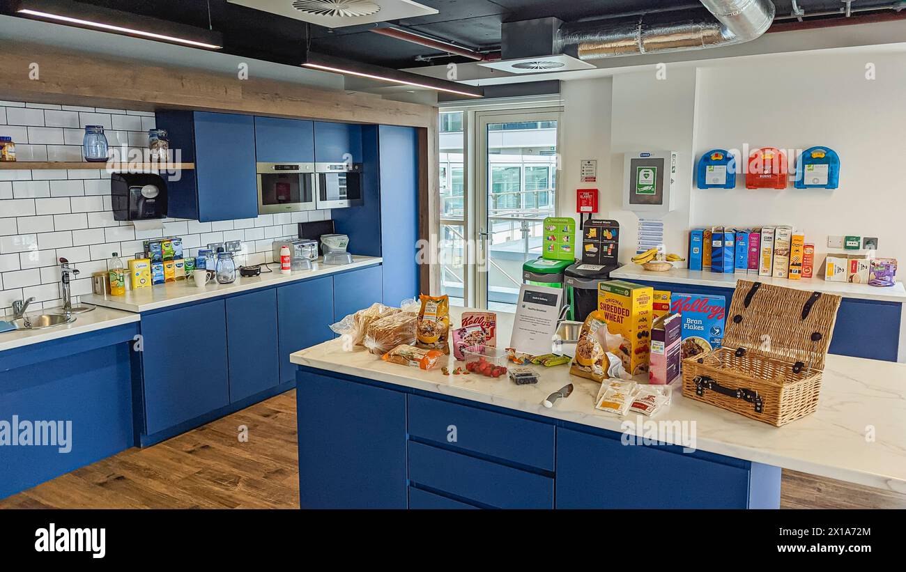 Kitchen area of a modern office, with tea and coffee facilities, and a wide range of breakfast cereals and breads for all staff. Stock Photo