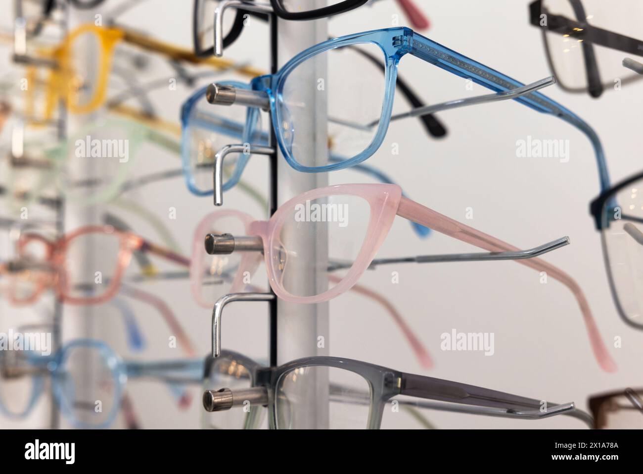 optics shop , few pairs of glasses on the display on the wall Stock Photo