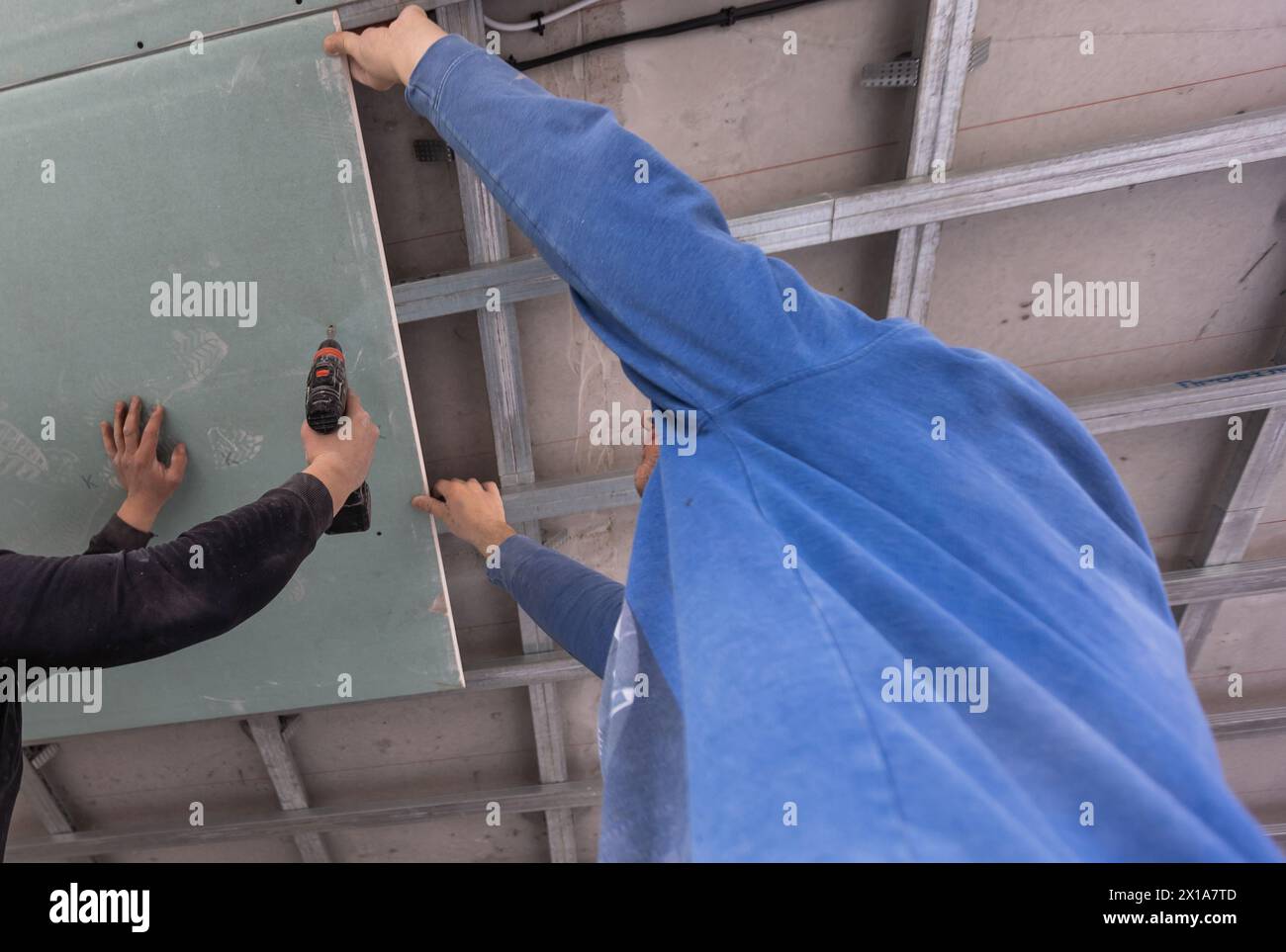 Man fasten ceiling profiles in hi-res stock photography and images - Alamy