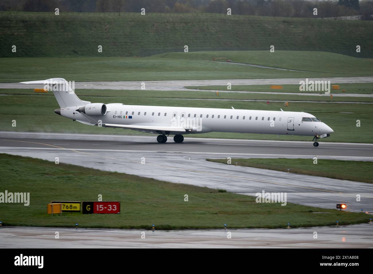 Cityjet Mitsubishi CRJ-100EC taking off in wet weather at Birmingham Airport, UK (EI-HIC) Stock Photo