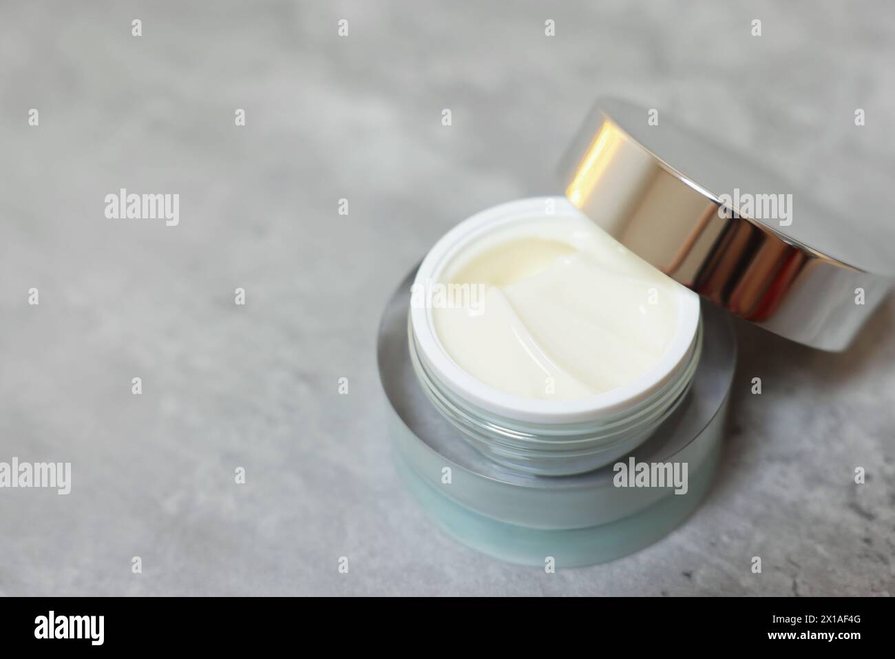 Body cream on grey table, closeup. Space for text Stock Photo