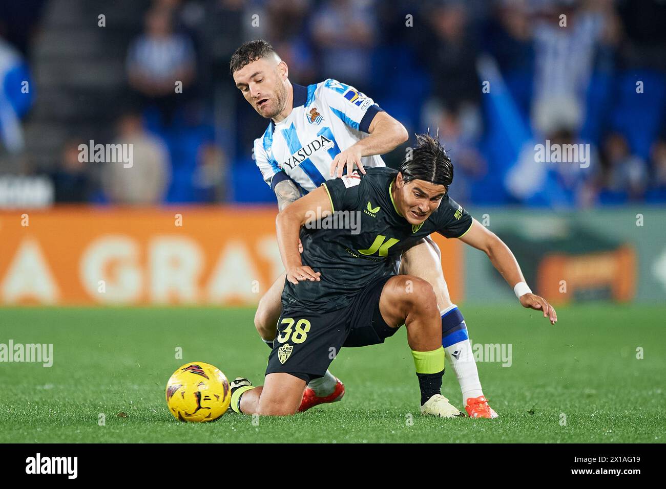 Javi Galan of Real Sociedad compete for the ball with Luka Romero of UD Almeria during the LaLiga EA Sports match between Real Sociedad and UD Almeria Stock Photo