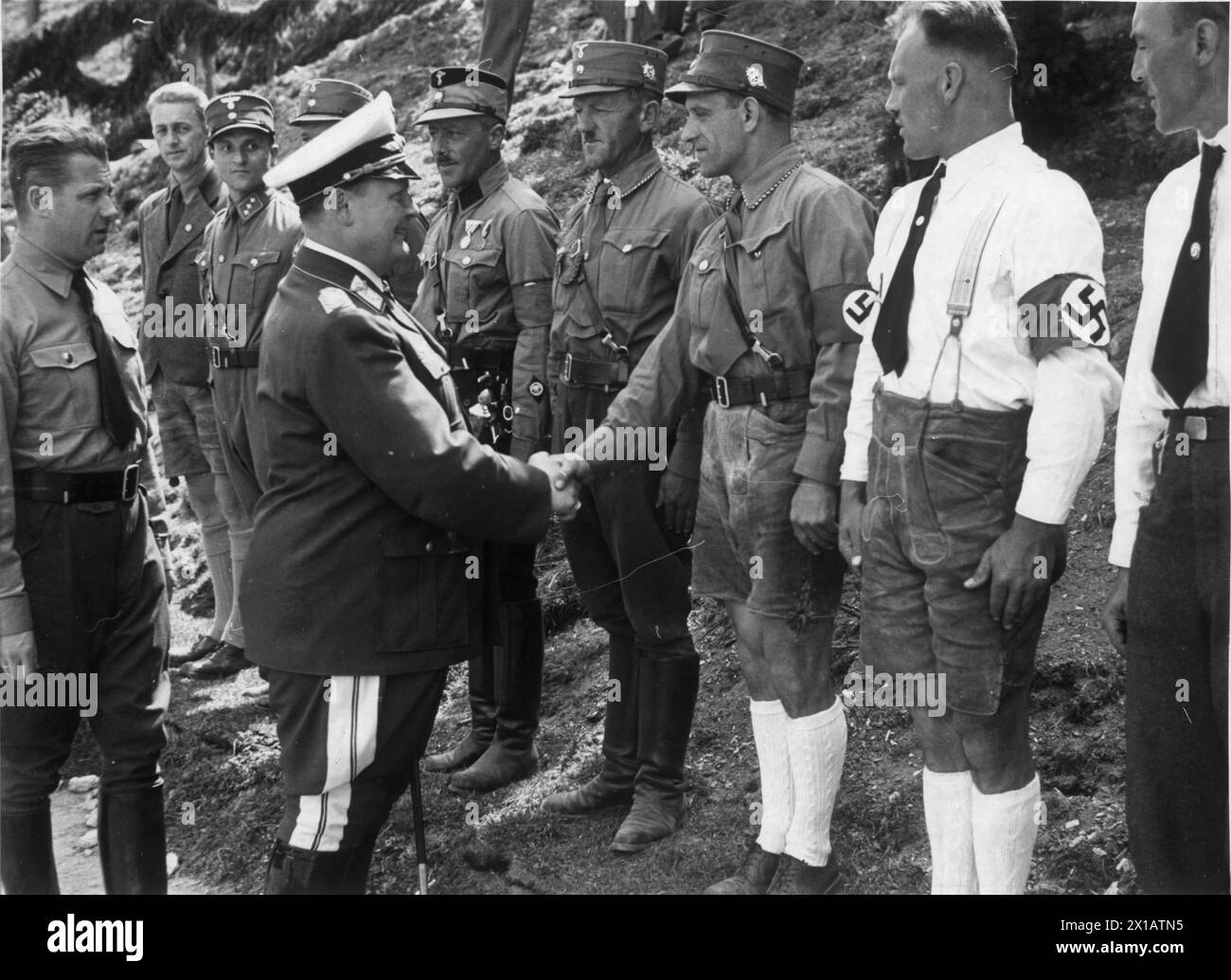 Hermann Goering in Kaprun, Goering welcome eight yore to the deaths sentence illegal Nazi from Salzburg. shaking hands of the 6th man in the progression in front of him., 16.05.1938 - 19380516 PD0019 - Rechteinfo: Rights Managed (RM) Stock Photo