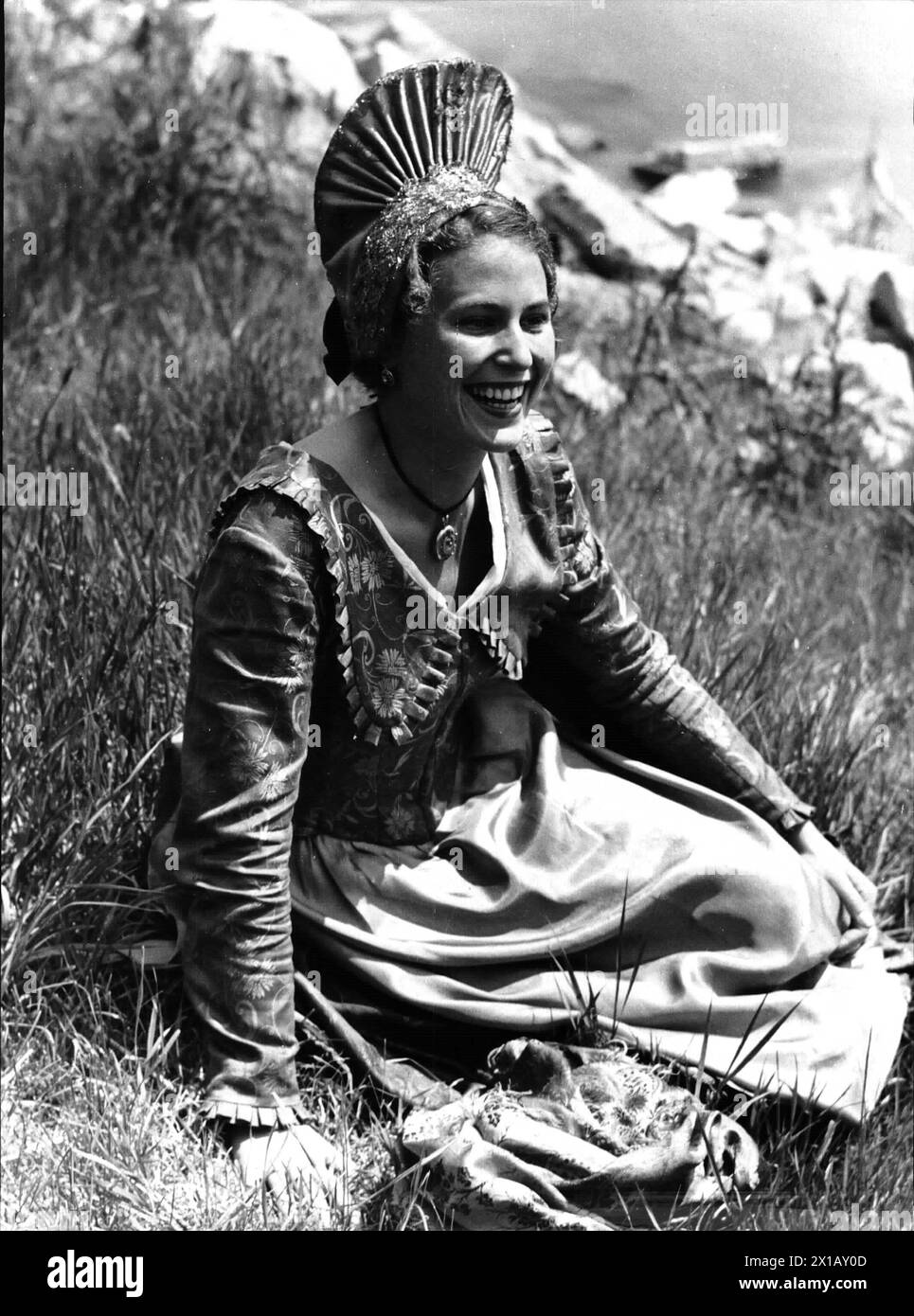 Traditional costume - Wachau, woman in Wachau traditional costume with, traditional costume - Wachau, woman in Wachau traditional costume with gold hood, in a meadow sitting, laugh, 1948 - 19480101 PD1054 - Rechteinfo: Rights Managed (RM) Stock Photo