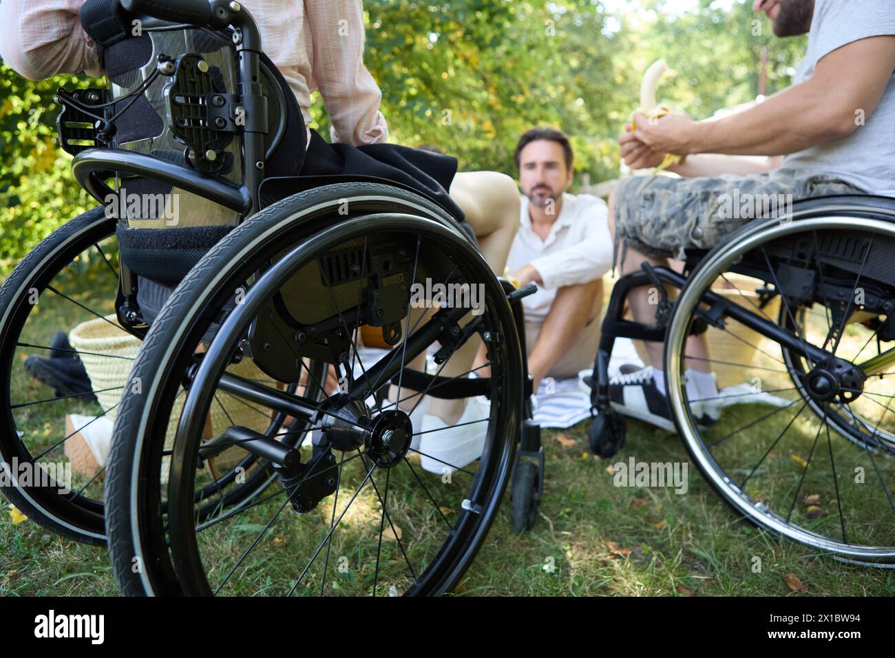 A peaceful outdoor scene featuring two men conversing, one of whom is ...