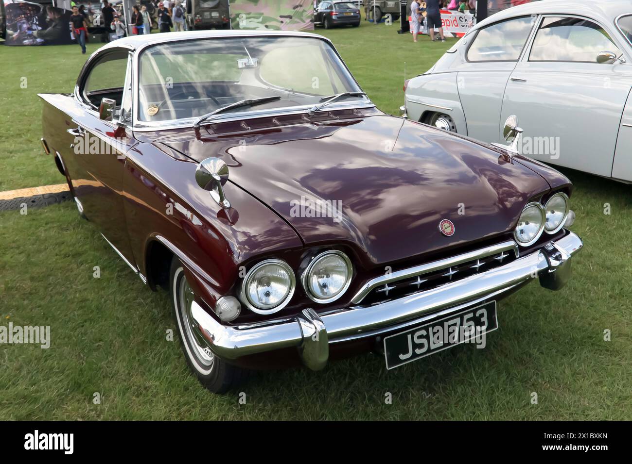 Three-quarter front view of a Maroon, 1972, Ford Consul Capri, on display at the 2023 British Motor Show Stock Photo