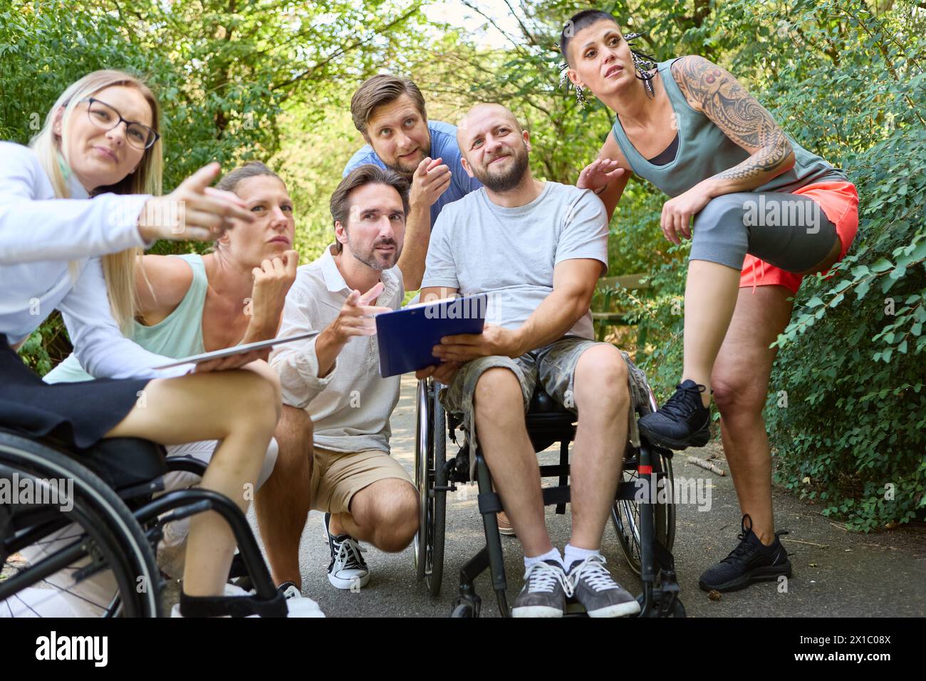 Diverse group of friends engaged in conversation, one using a ...