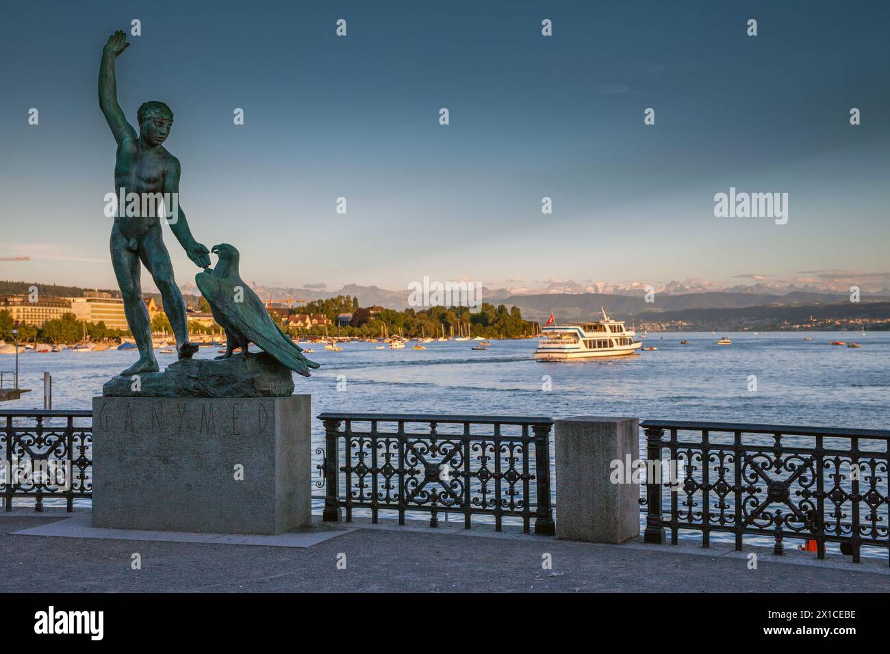 View of the Lake Zurich (Zürichsee) with the Ganymed statue in the foreground. It is a prominent sculpture by Lake Zurich, created by Hermann Hubacher Stock Photo