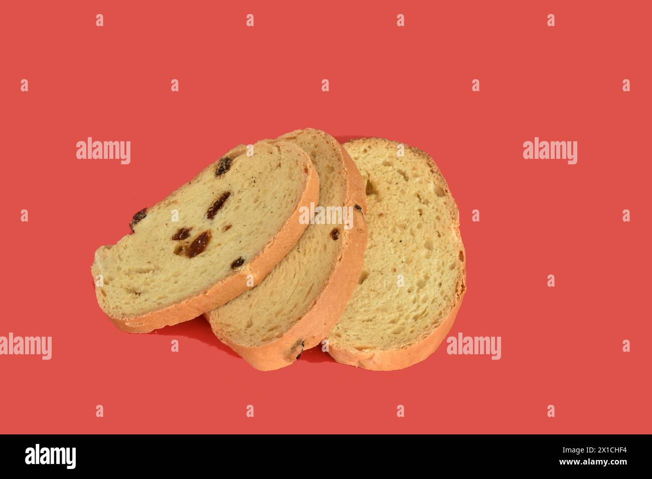 Several crackers with raisins lie on a red background. Stock Photo