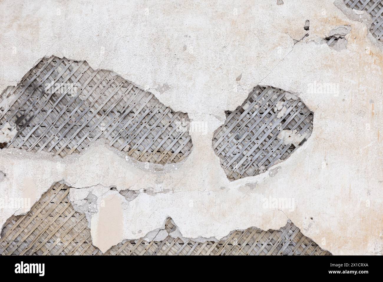 Ancient wooden wall with damaged stucco layer placed over wooden lathing for plaster Stock Photo