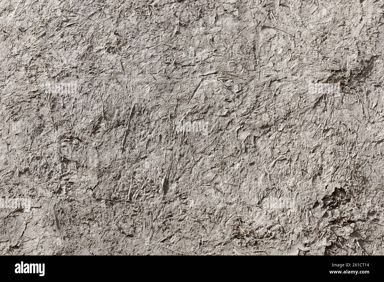 Ancient gray adobe wall, close up background photo texture Stock Photo