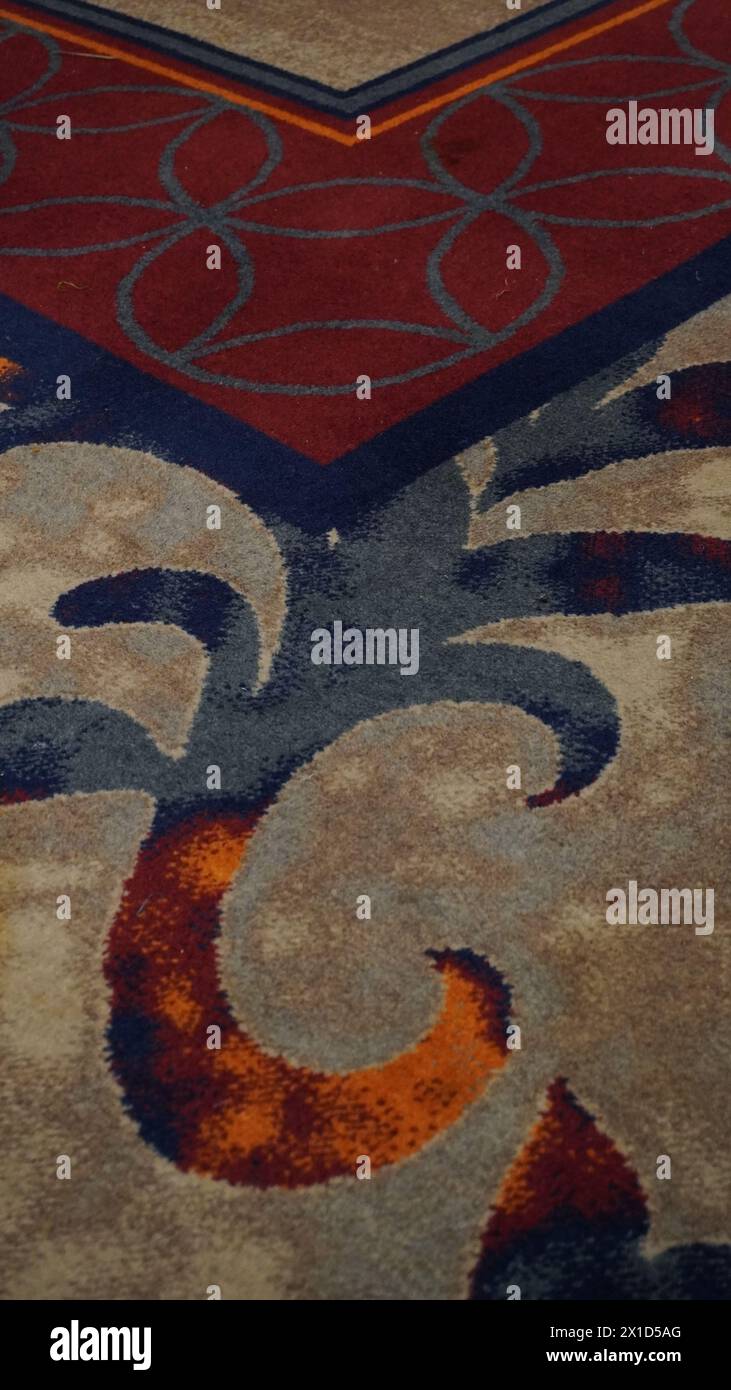 Batik motif on the carpet in red and blue Stock Photo