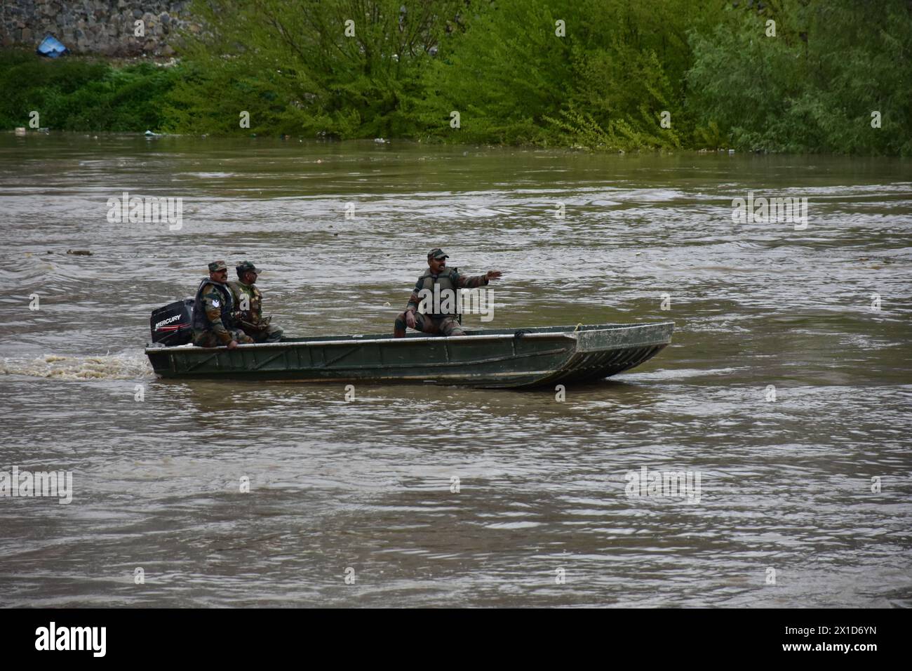 Rescuers of the Indian army seen on a search after a boat carrying people including children capsized in Jhelum river on the outskirts of Srinagar. A boat carrying a group of people has capsized in a river, drowning six of them. Most of the passengers were children on their way to school, and rescuers are searching for the missing. Stock Photo