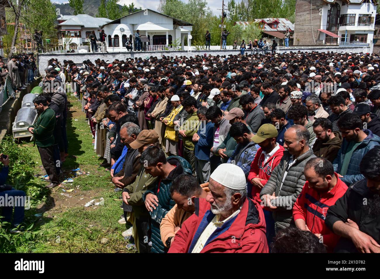 Relatives and residents offer funeral prayers of victims who died after a boat capsized in Jhelum river on the outskirts of Srinagar. A boat carrying a group of people has capsized in a river, drowning six of them. Most of the passengers were children on their way to school, and rescuers are searching for the missing. Stock Photo