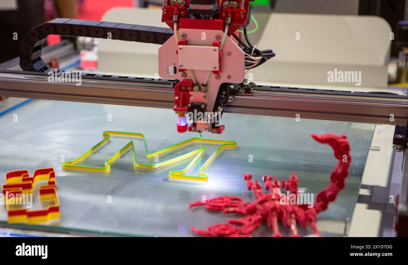 Three dimensional 3d printer printing letter M. Stock Photo