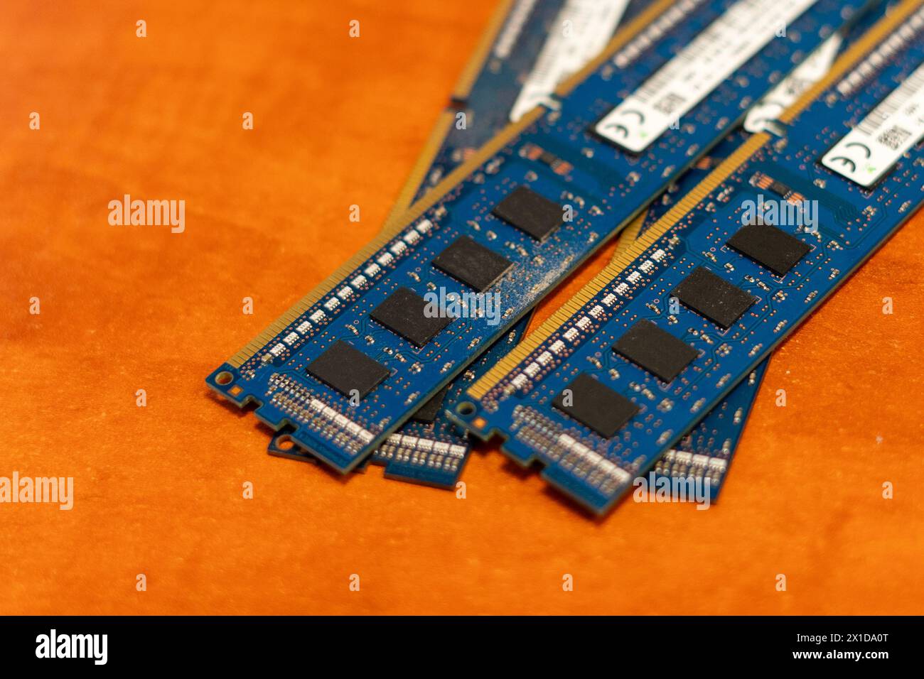 Blue RAM memories on top of each other with an orange background Stock Photo