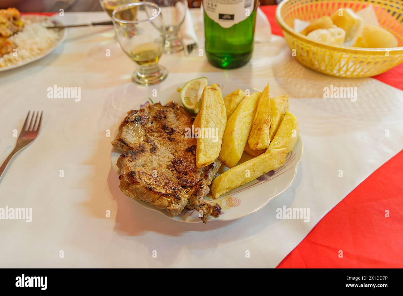 Llama steak with fries served in a restaurant in Huamahuaca, Jujuy, Argentina. Stock Photo