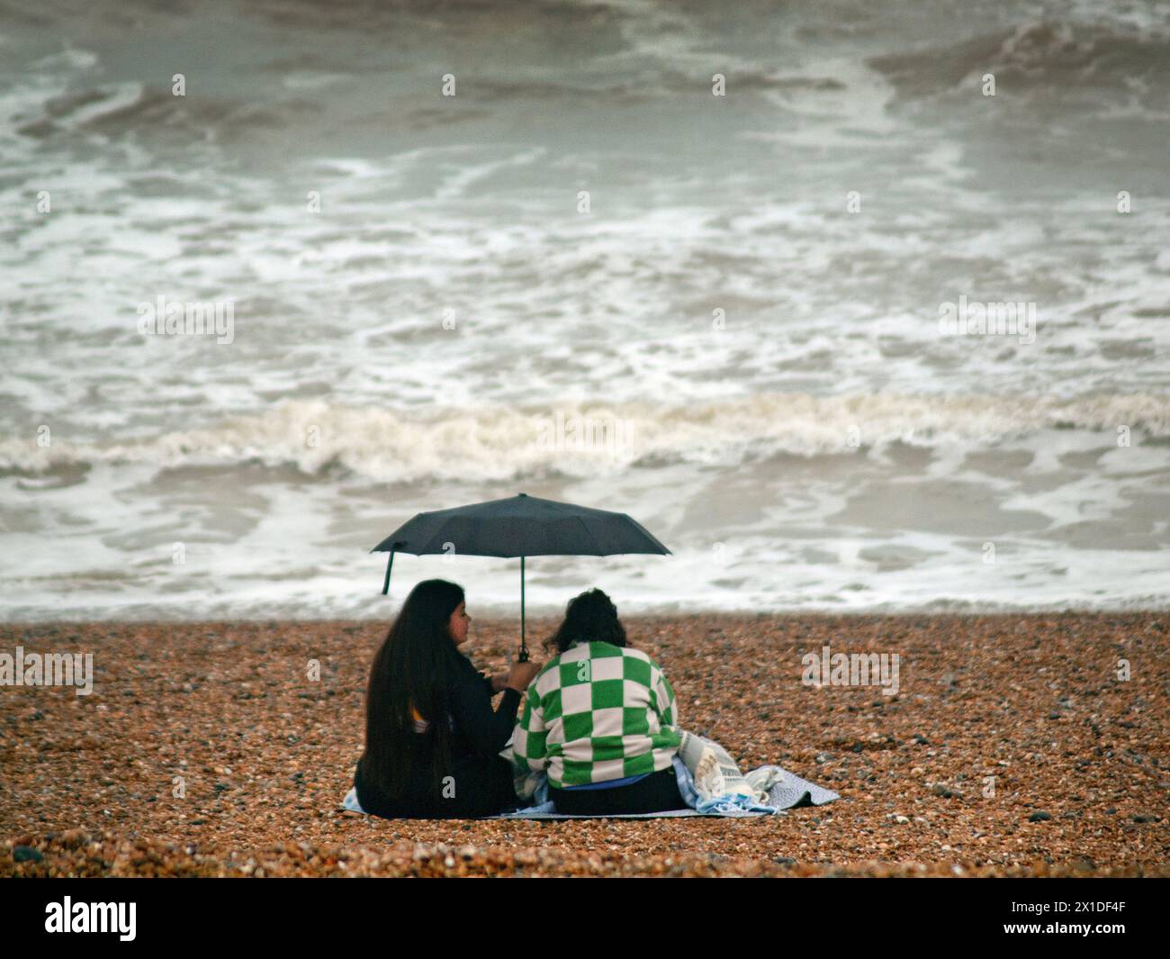 A wet day on the beach at Brighton Stock Photo