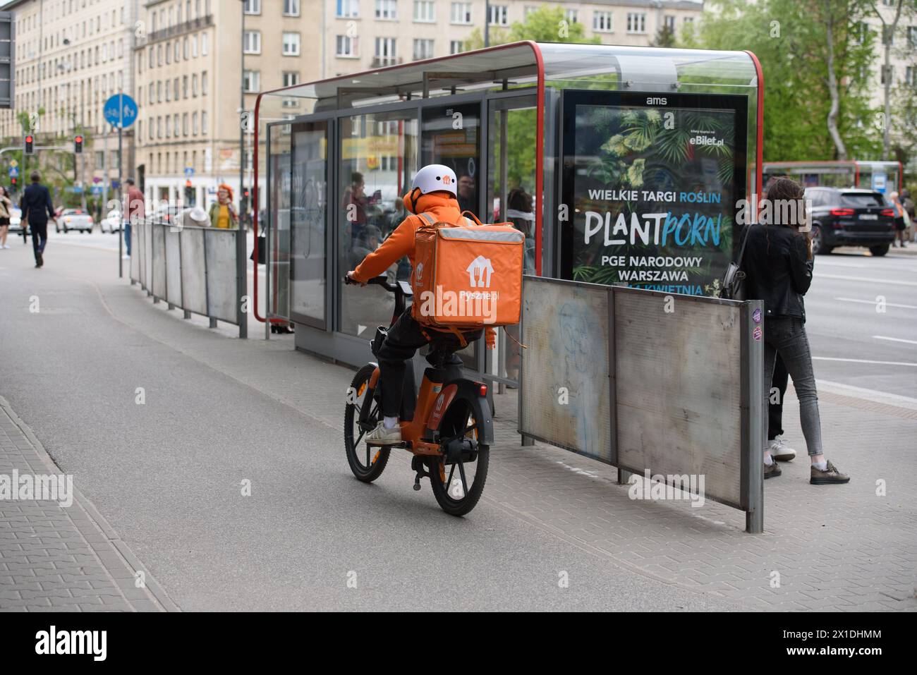 Daily Life in Warsaw. A Pyszne.pl Just Eat Takeaway.com food delivery courier rides his bike in Warsaw, Poland on April 14, 2024. Warsaw Poland Copyright: xAleksanderxKalkax Stock Photo