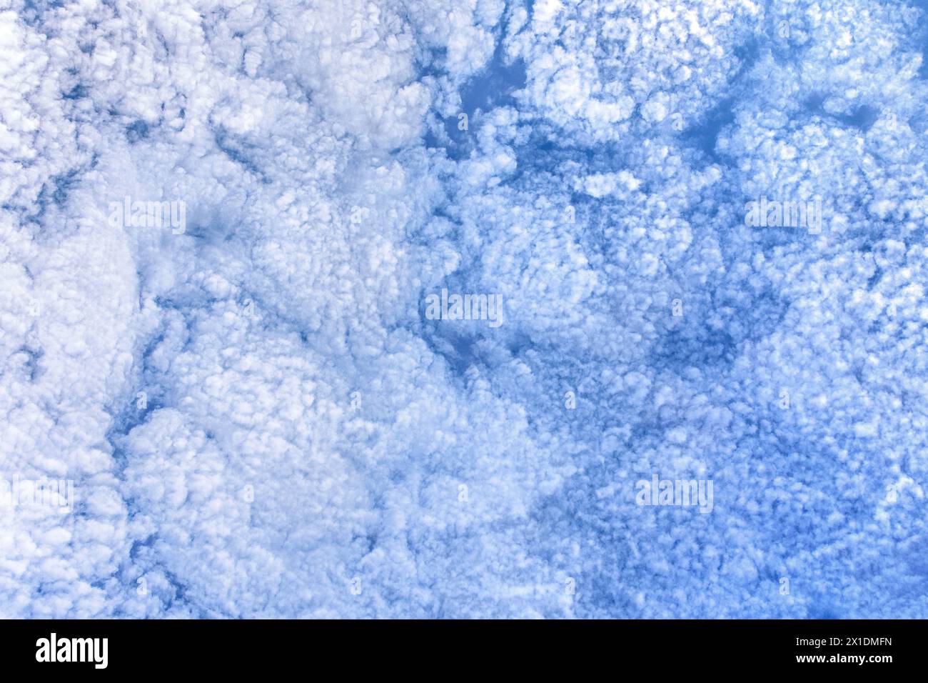 Altocumulus fluffy white clouds - atmospheric weather. Stock Photo