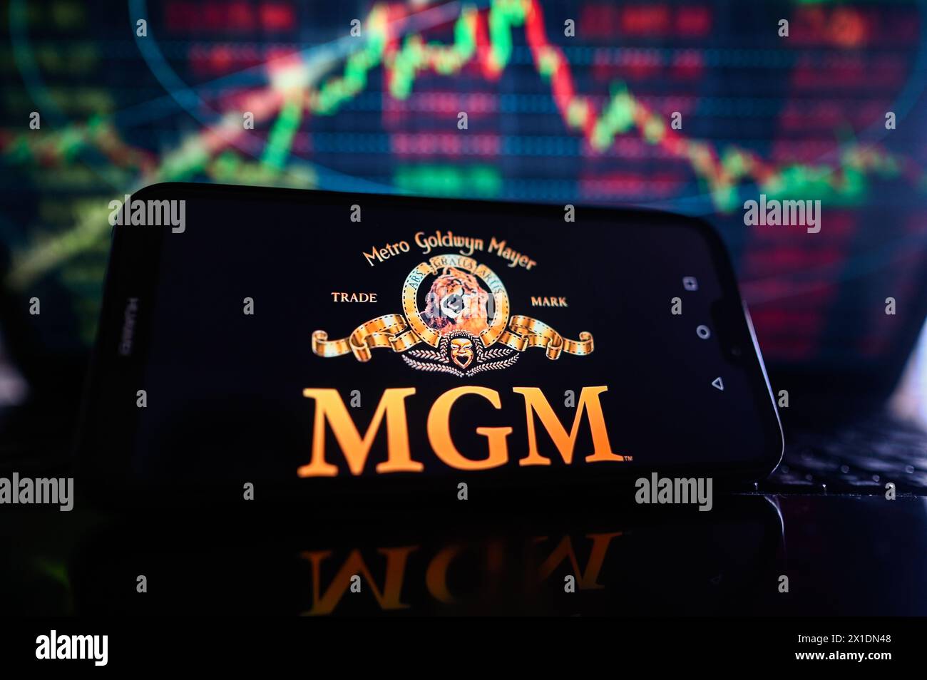 Poland. 16th Apr, 2024. In this photo illustration, an MGM logo is displayed on a smartphone with stock market percentages in the background. (Photo by Omar Marques/SOPA Images/Sipa USA) *** Strictly for editorial news purposes only *** Credit: Sipa USA/Alamy Live News Stock Photo