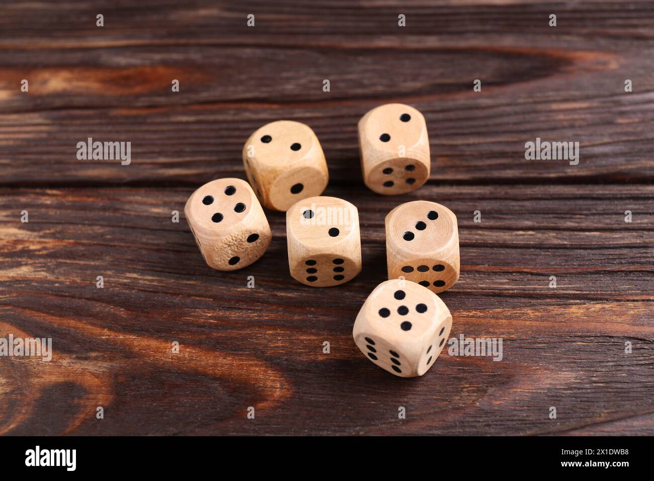 Many dices on wooden table. Game cubes Stock Photo