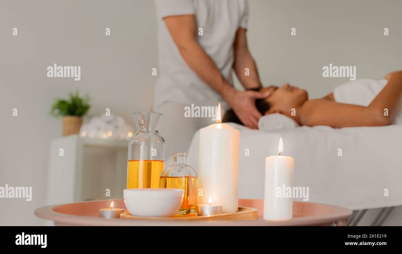 Tranquil spa setting with oils and black lady Stock Photo