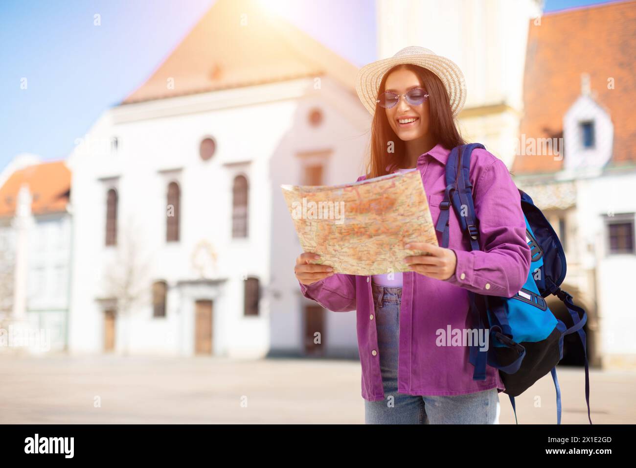 Traveling student reading a map in sun Stock Photo