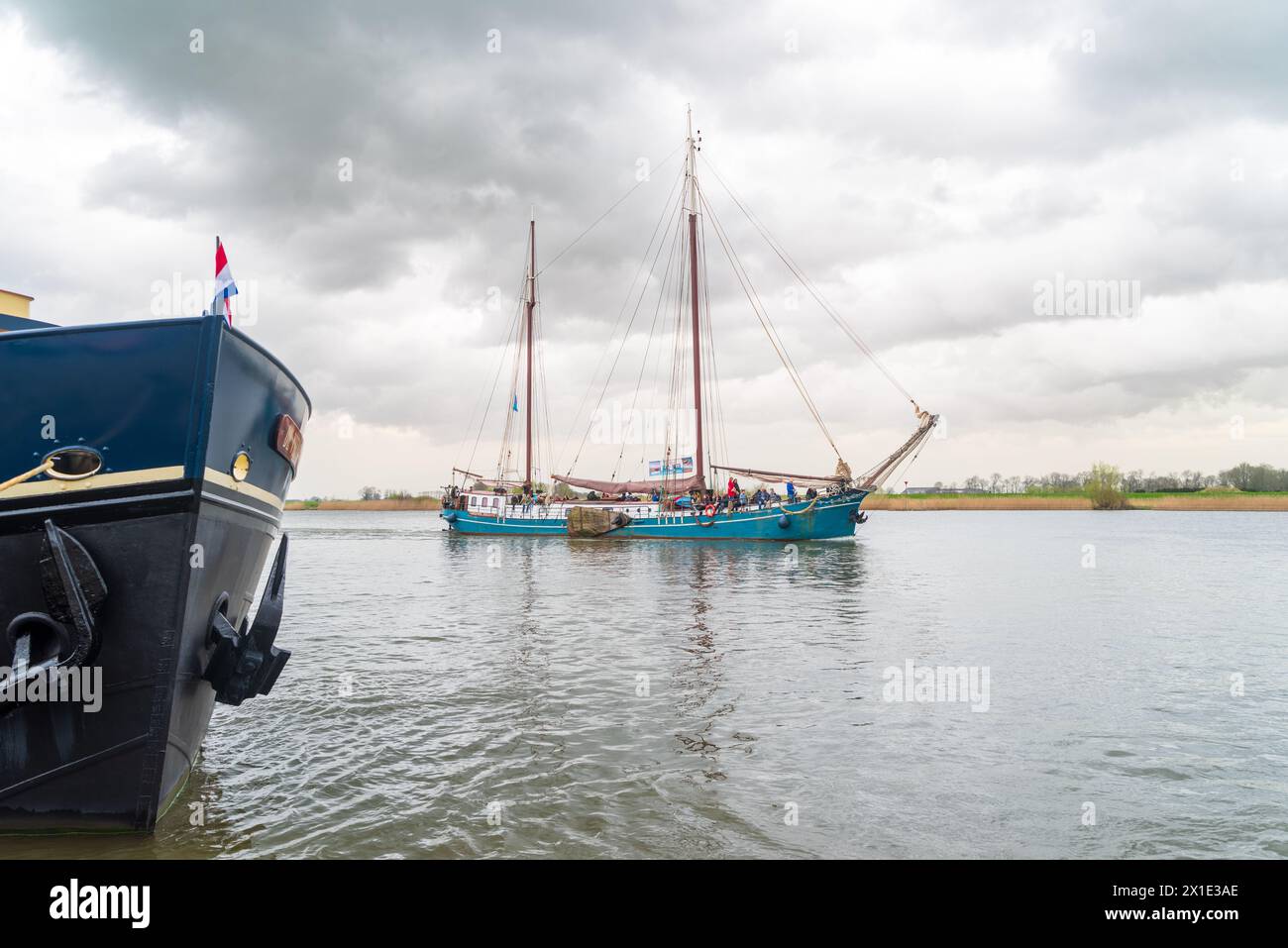 KAMPEN, NETHERLANDS - MARCH 30, 2024: Sailing boats on the IJssel river during Sail Kampen, a large event during the Easter weekend. Stock Photo