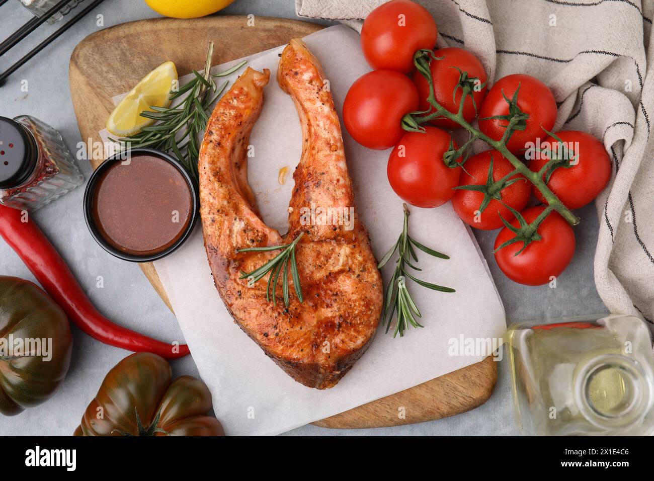Fresh marinade, cooked fish and other products on grey table, flat lay ...