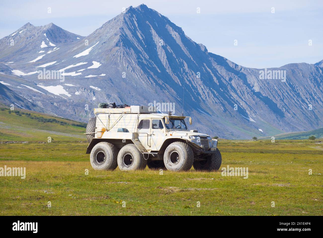 YAMAL, RUSSIA - AUGUST 27, 2018: The Trekol all-terrain vehicle against the background of mountains of Polar Ural in the sunny summer day Stock Photo