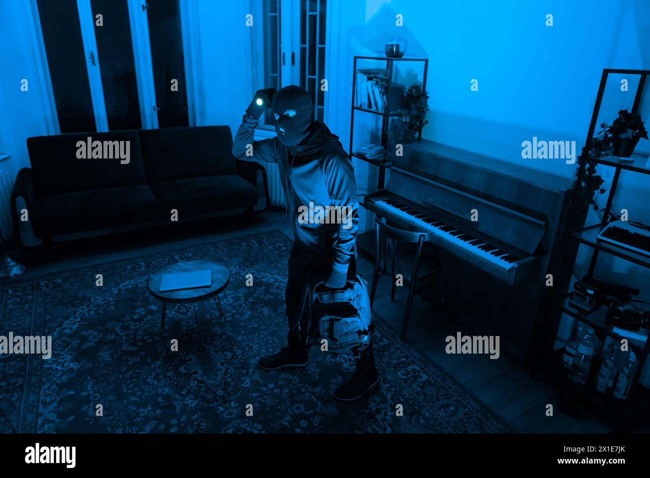 Burglar with flashlight in dark room, break in Stock Photo Alamy