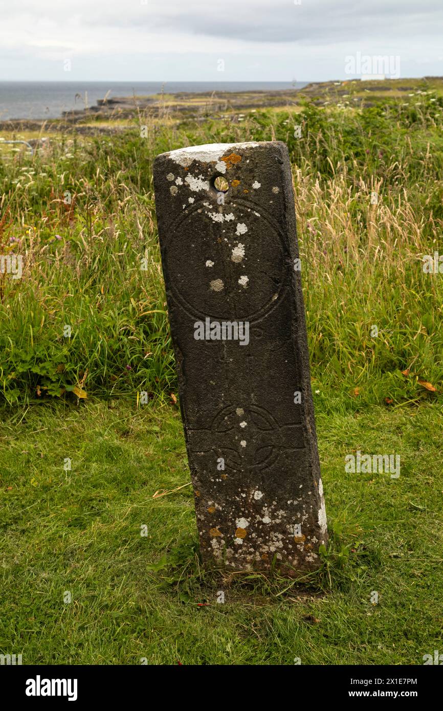 Inscribed standing stone or sundial beside Teampall Chiarain on Inishmore island in the Aran islands on the Wild Atlantic Way in Galway in Ireland Stock Photo