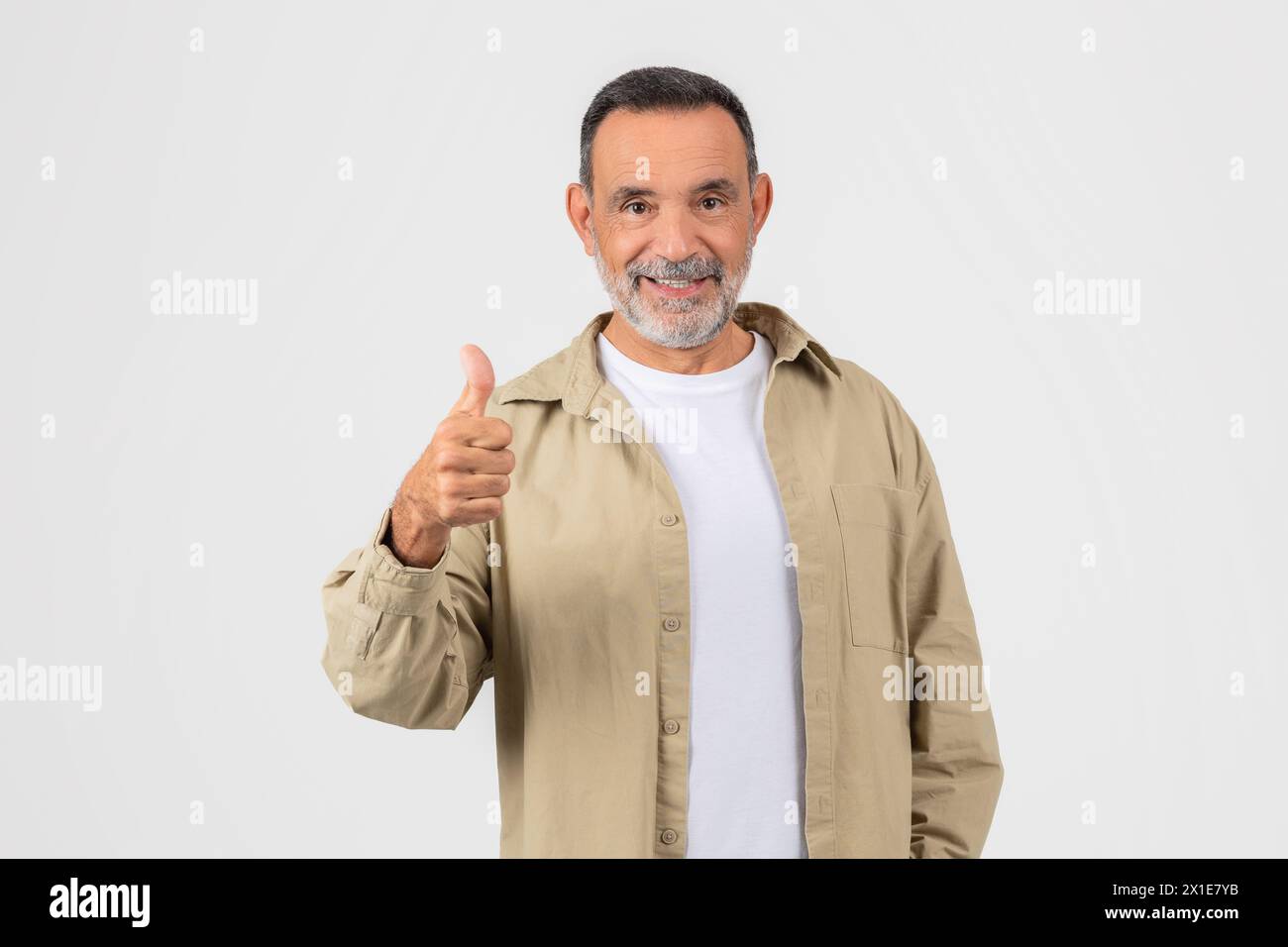 Senior man giving thumbs up with a smile Stock Photo