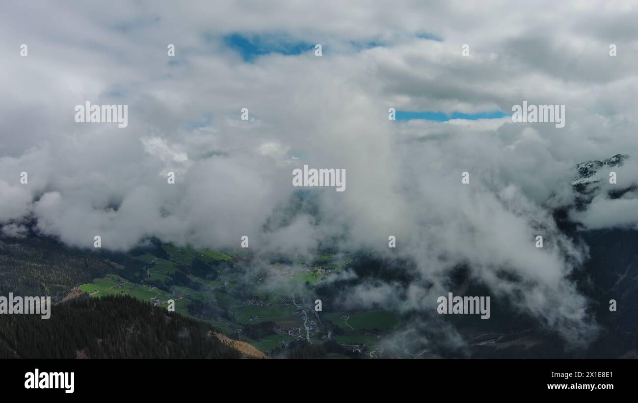 Aerial view of snowcapped mountains in clouds Stock Photo - Alamy