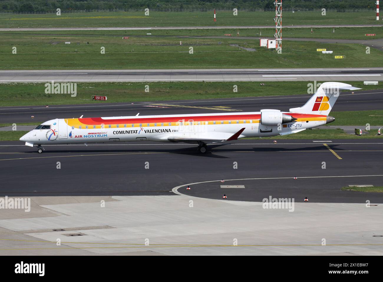 Spanish Air Nostrum Bombardier CRJ900 with registration EC-JTU in Iberia Regional livery on taxiway at Dusseldorf Airport Stock Photo