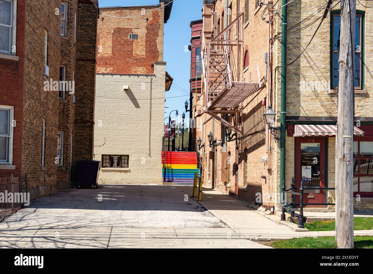 Old storefront and alleyway with staircase painted in rainbow colors