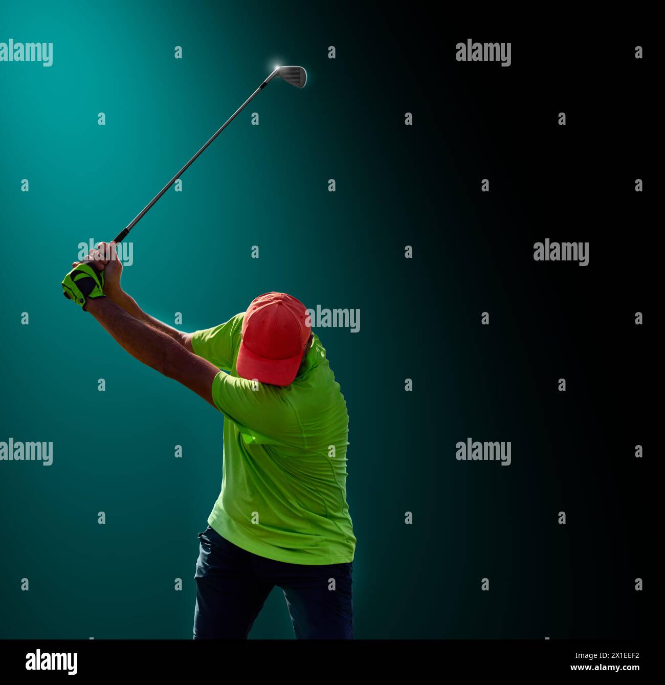 Golfer on a golf course, ready to tee off. Golfer with golf club hitting the ball for the perfect shot. Stock Photo
