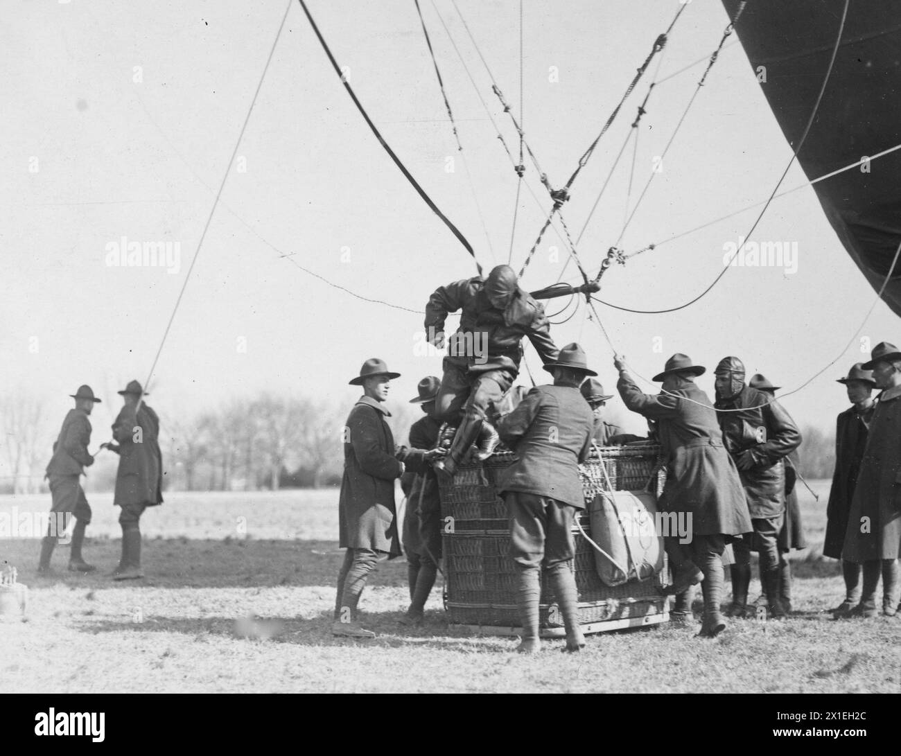 Balloon operations. Passenger jumping from basket of Caquot Balloon operated by 27th Balloon Co., Polo Field, Washington, D.C ca. 1919 Stock Photo