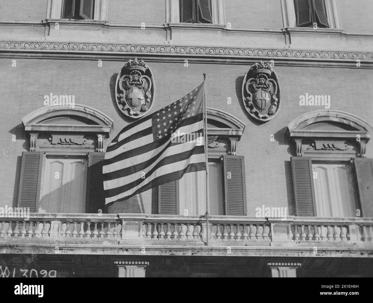 The American flag flies in front of the home of Queen Mother of Italy for first time in History when President and Mrs. Wilson leave the mansion ca. 1919 Stock Photo
