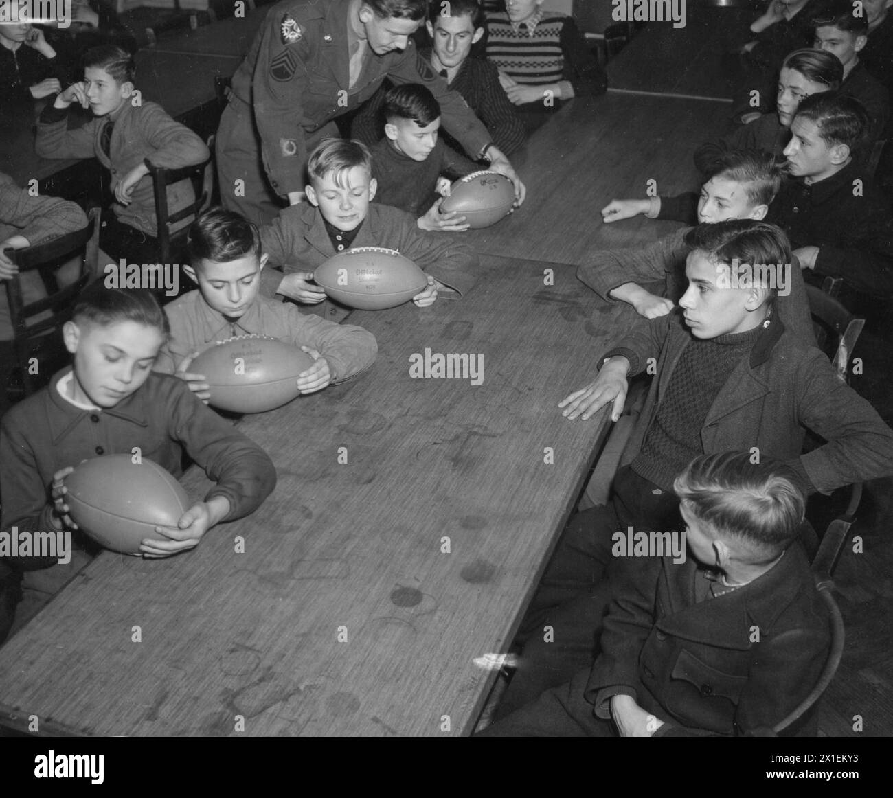 Staff Sergeant Lewis Karker Shown Teaching a Group of German Youths, the Basic Principles of American Football ca. 1940s Stock Photo