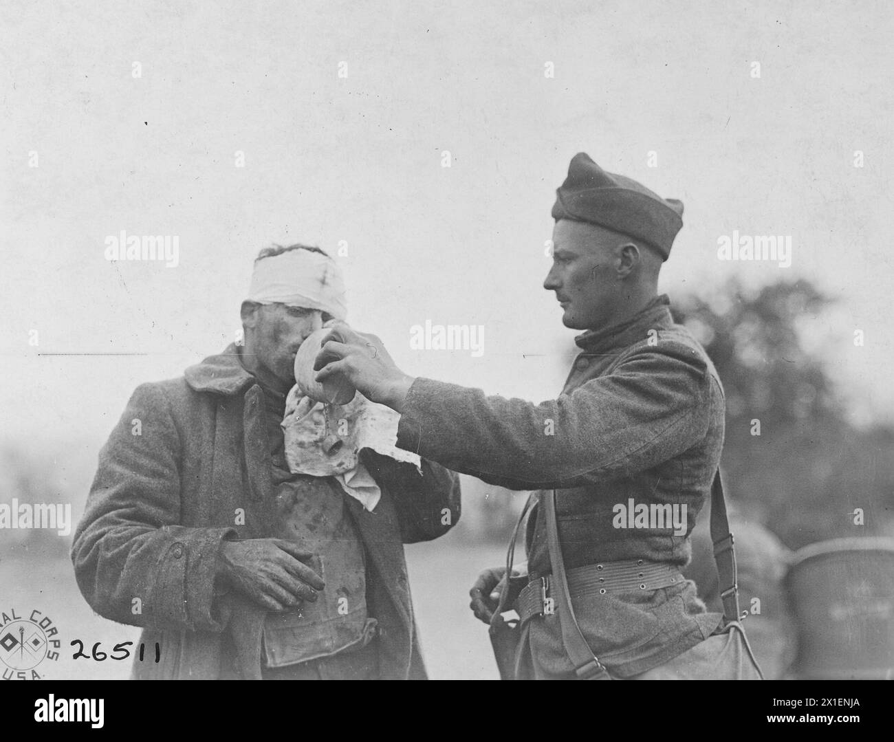 World War I Photos: A soldier provides one of his wounded comrades a drink ca. 1918 Stock Photo