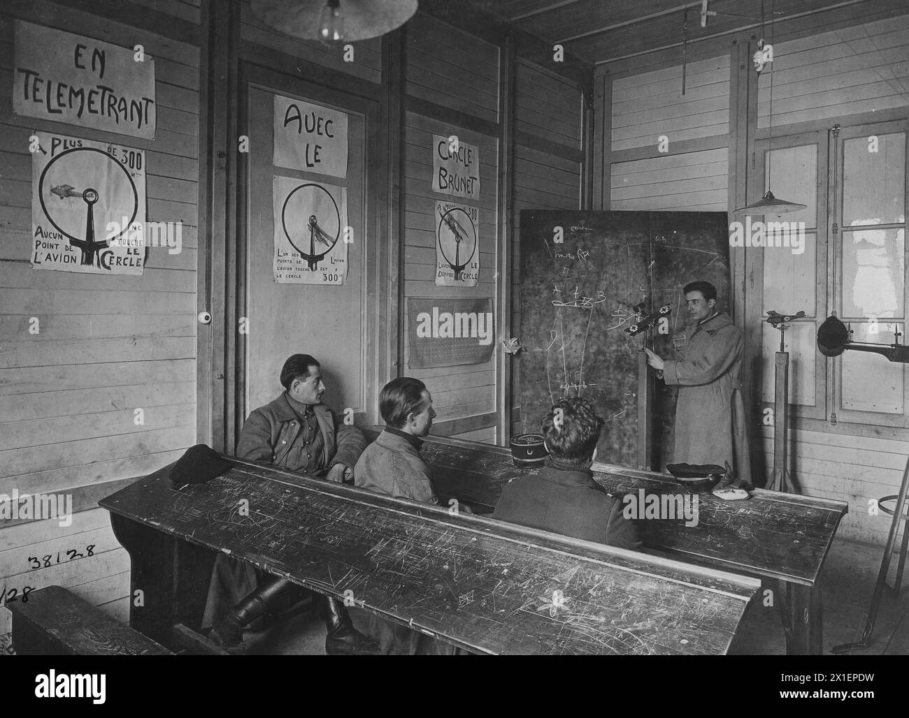 Original caption: An instructor teaches a class on deflection moving target and moving shooter. Insturctor is explaining how to allow for deflection; France ca. 1919 Stock Photo