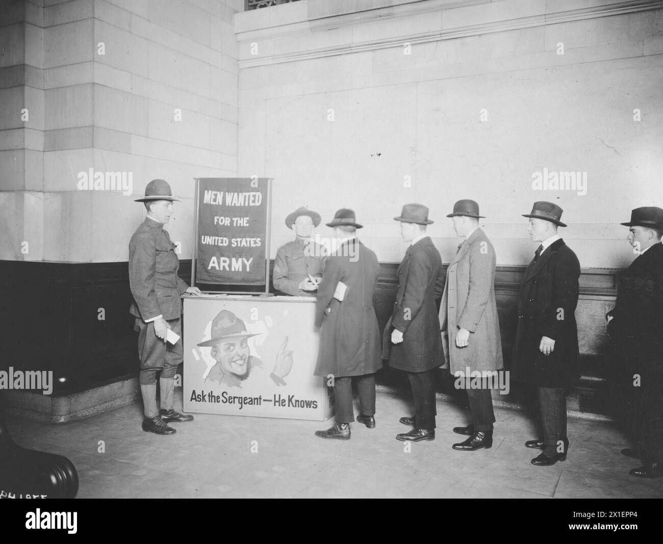 U.S. Army recruitng poster, men stand in line waiting to receive information ca. 1918-1921 Stock Photo