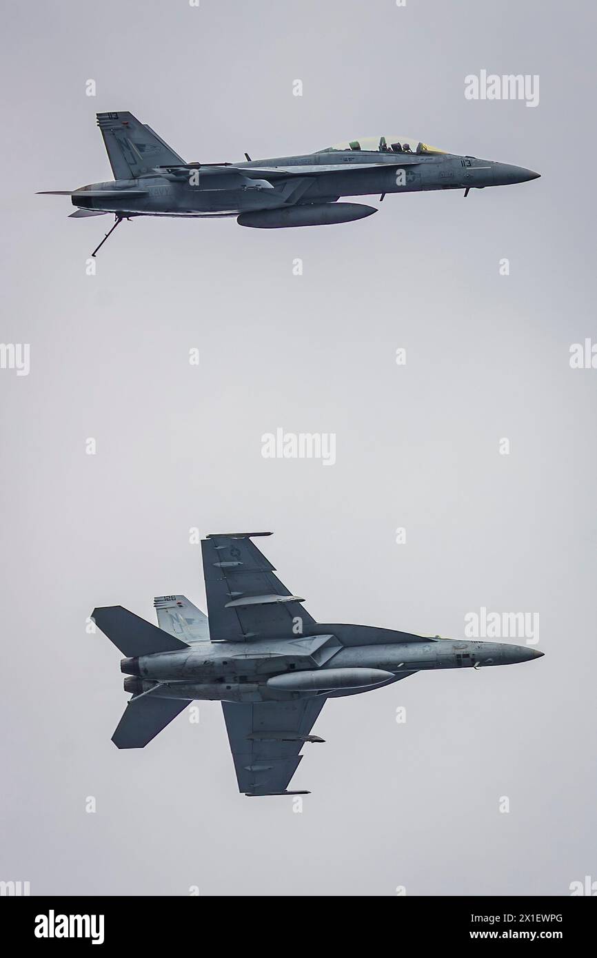 USS Abraham Lincoln, United States. 13 April, 2024. Two U.S. Navy F/A-18F Super Hornet fighter aircraft, attached to the Flying Eagles of Strike Fighter Squadron 122, perform a fly past the Nimitz-class aircraft carrier USS Abraham Lincoln during an air power demonstration for Family Day, April 13, 2024 on the Pacific Ocean.  Credit: MC2 Clayton Wren/US Navy Photo/Alamy Live News Stock Photo