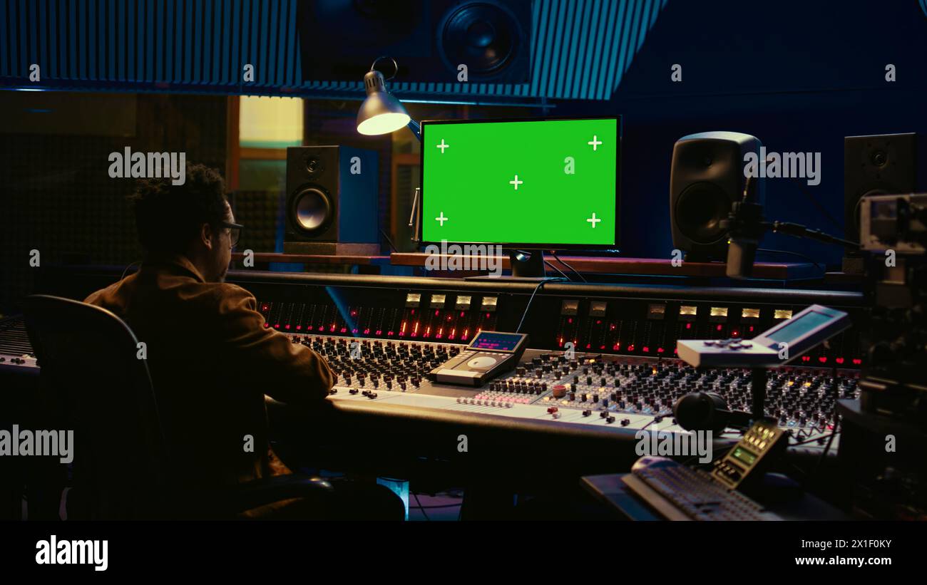 African american sound engineer working in control room with mixing ...