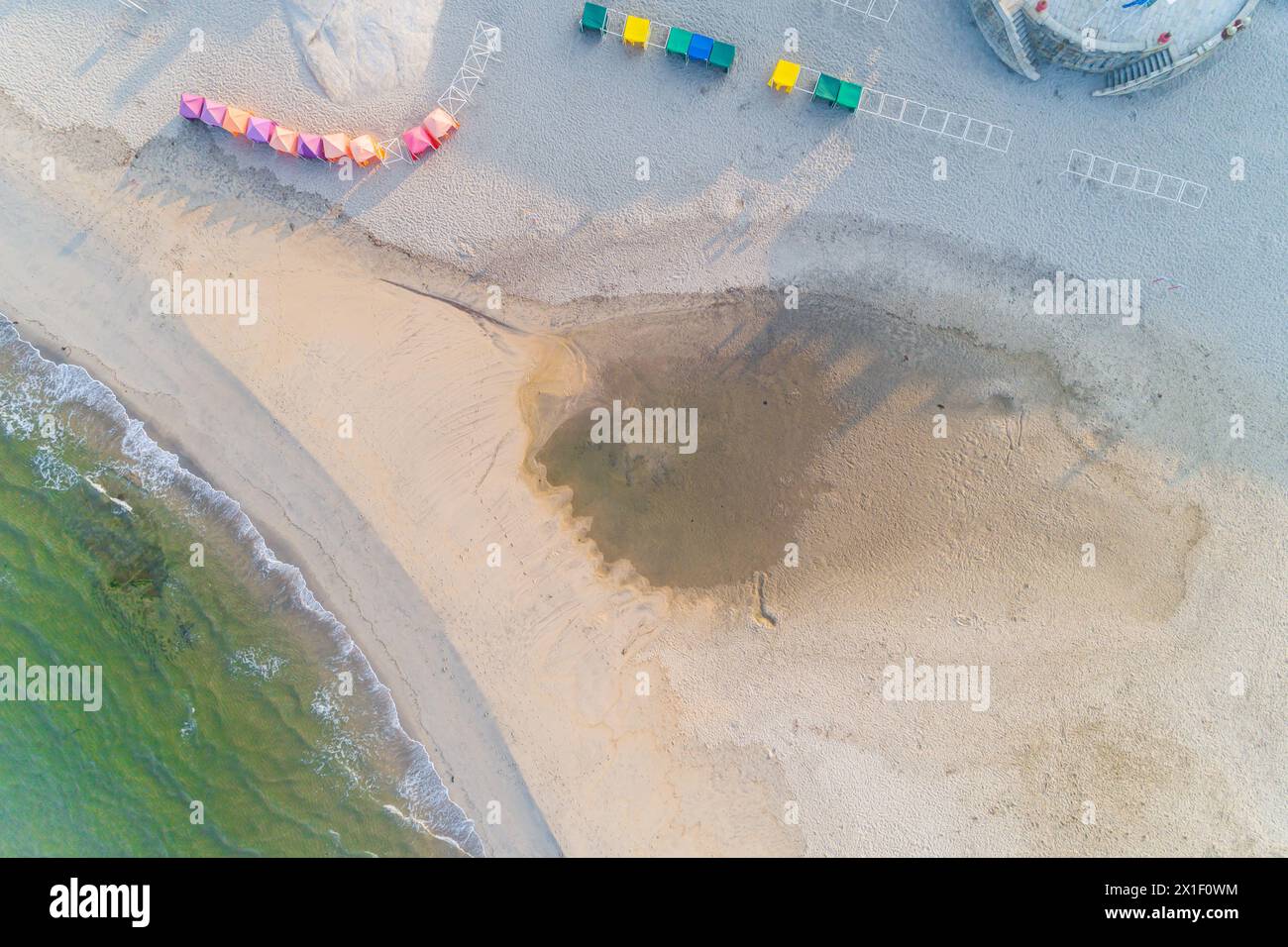 zenithal aerial view of an empty beach in summer at sunrise, drone shot Stock Photo